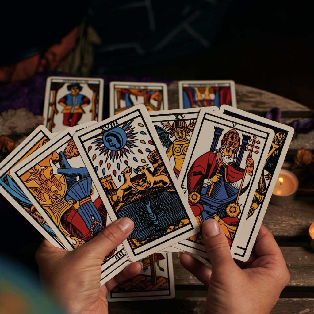 Close-up of a fortune teller reading tarot cards